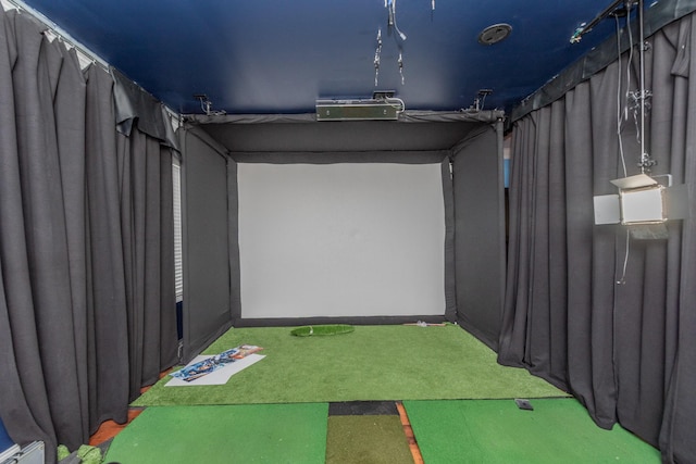 rec room with carpet floors and golf simulator