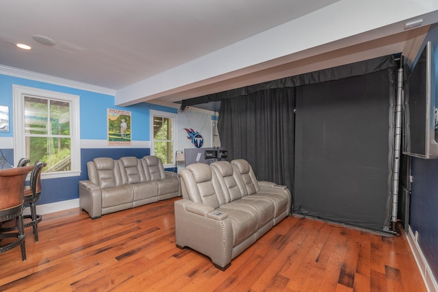 living area featuring wood finished floors, recessed lighting, ornamental molding, and baseboards
