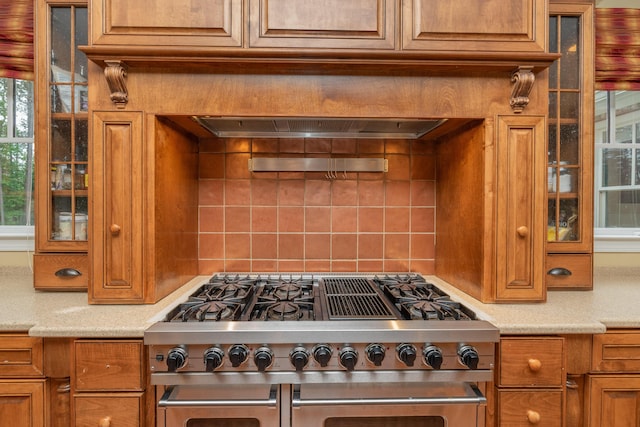 211 Ronda Ct, Grovetown, GA 30813 - kitchen with double oven range, brown cabinets, backsplash, glass insert cabinets, and light stone counters
