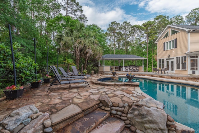 pool with french doors, a patio area, and outdoor dry bar