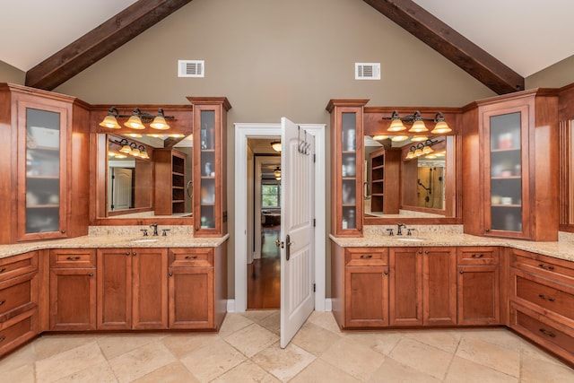 bathroom featuring vanity, visible vents, and high vaulted ceiling