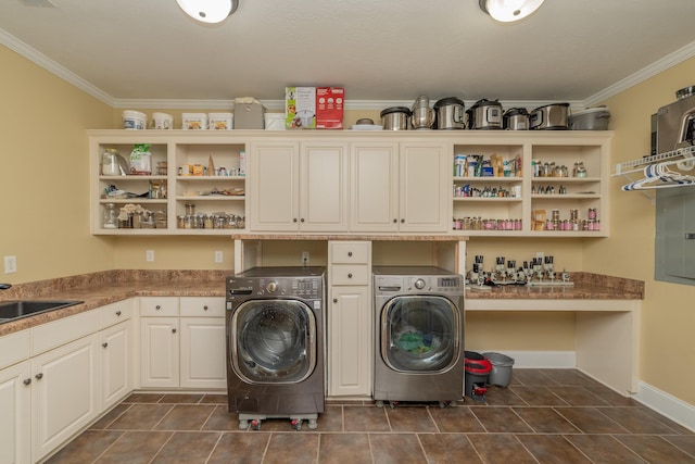 laundry room with ornamental molding, separate washer and dryer, cabinet space, and electric panel