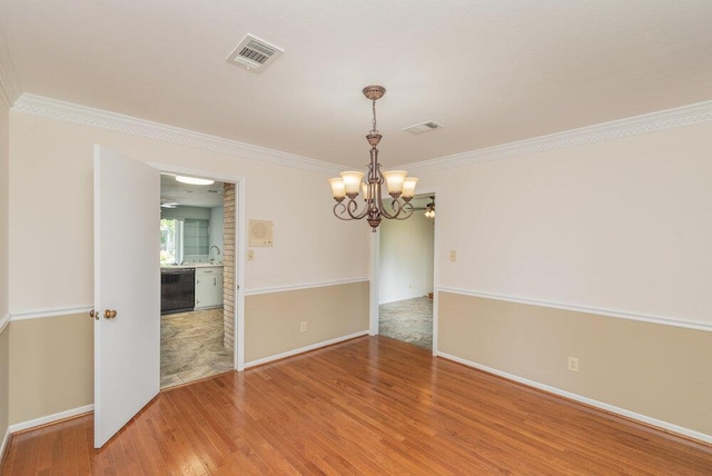 3411 Kamel Cir, Augusta, GA 30909 - empty room with a chandelier, wood finished floors, baseboards, and crown molding