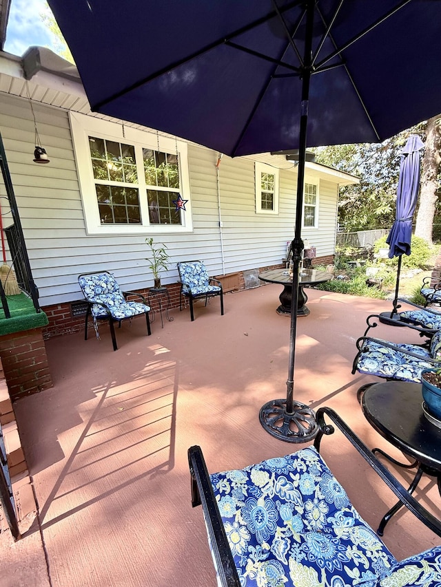 view of patio featuring fence