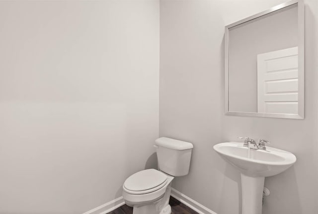 3445 Firestone Dr, Hephzibah, GA 30815 - bathroom featuring baseboards, a sink, wood finished floors, and toilet