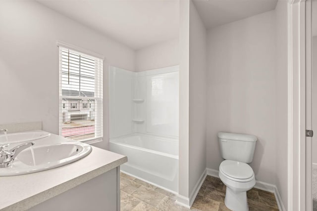 3445 Firestone Dr, Hephzibah, GA 30815 - full bath featuring stone tile floors, double vanity, toilet, baseboards, and a sink