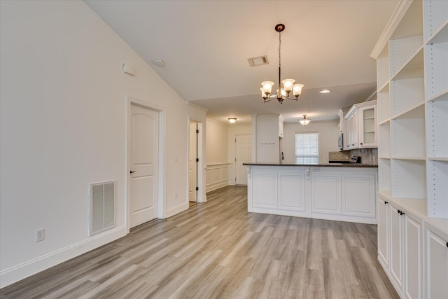 kitchen with open shelves, light wood-style floors, a chandelier, white cabinets, and recessed lighting