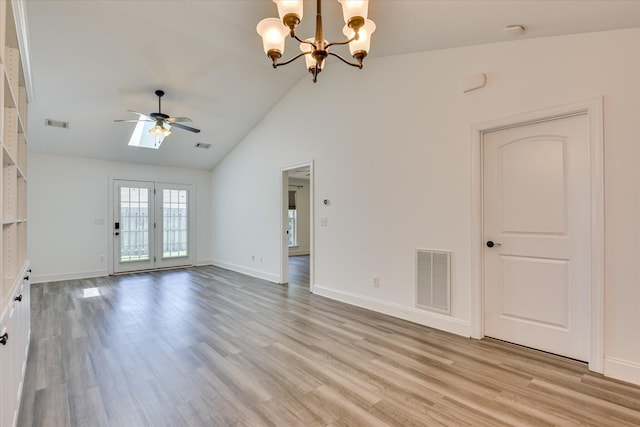 unfurnished living room with a ceiling fan, light wood-style floors, a chandelier, baseboards, and high vaulted ceiling