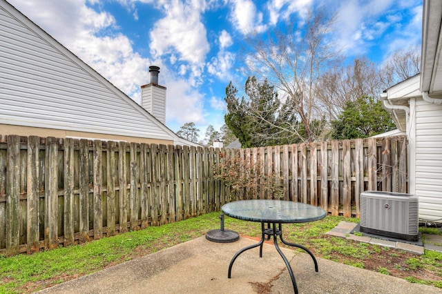 view of patio / terrace with central AC unit and a fenced backyard