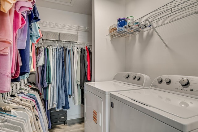 laundry area featuring laundry area, washer and clothes dryer, and light wood finished floors