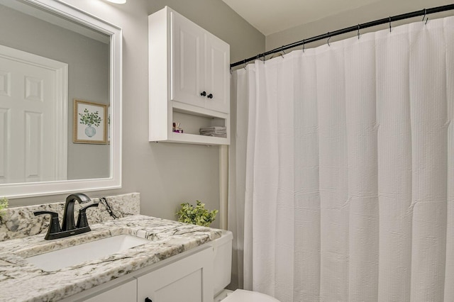 bathroom with toilet and vanity