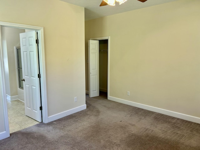 unfurnished bedroom featuring baseboards, a ceiling fan, and carpet flooring