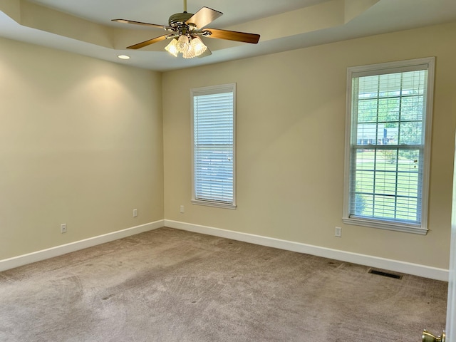 empty room with baseboards, plenty of natural light, and visible vents
