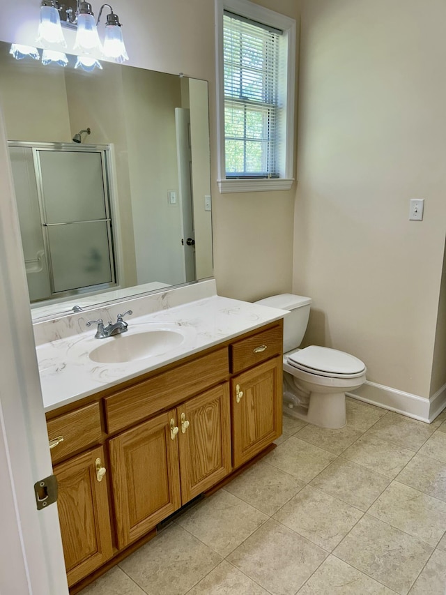 full bath with a shower with shower door, tile patterned floors, baseboards, vanity, and toilet
