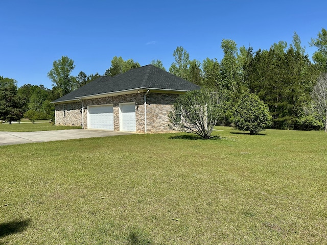 view of side of home with a lawn, brick siding, concrete driveway, and a garage