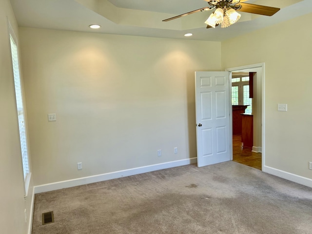empty room with carpet floors, a ceiling fan, baseboards, recessed lighting, and visible vents