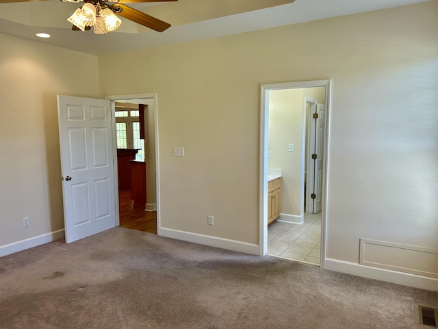 unfurnished bedroom featuring visible vents, baseboards, ensuite bathroom, light carpet, and recessed lighting