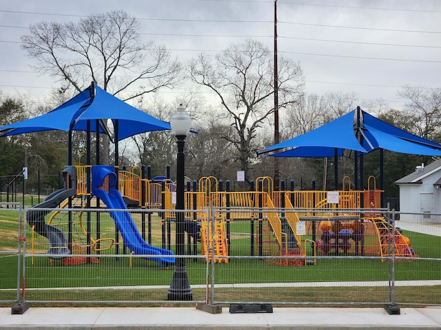 communal playground with a lawn and fence