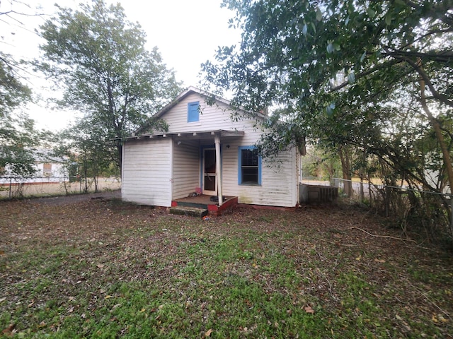 rear view of house with fence