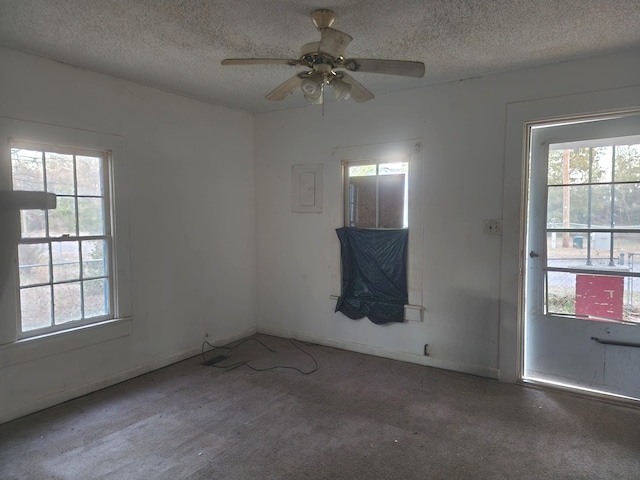 empty room with baseboards, a textured ceiling, and a ceiling fan