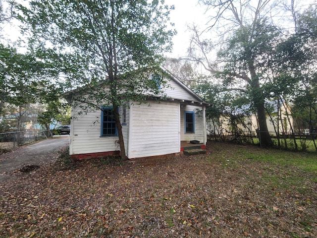 view of outbuilding with fence