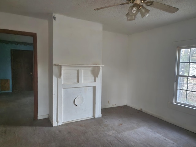 unfurnished living room featuring ceiling fan, carpet flooring, and a textured ceiling