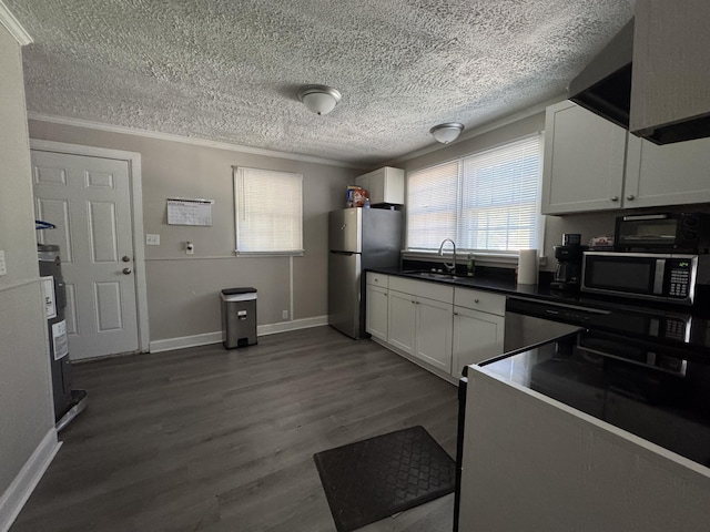 2402 Wheeless Rd, Augusta, GA 30906 - kitchen featuring stainless steel appliances, a textured ceiling, healthy amount of natural light, white cabinetry, and ornamental molding