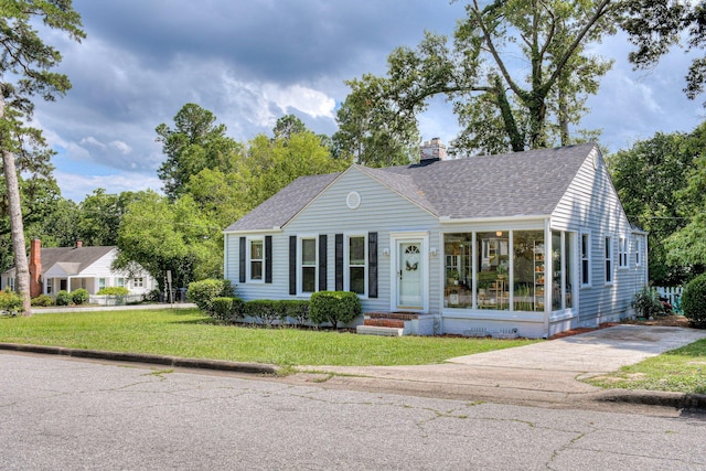 1703 Holly Hill Rd, Augusta, GA 30904 - view of front facade with a shingled roof, a chimney, a front yard, and driveway