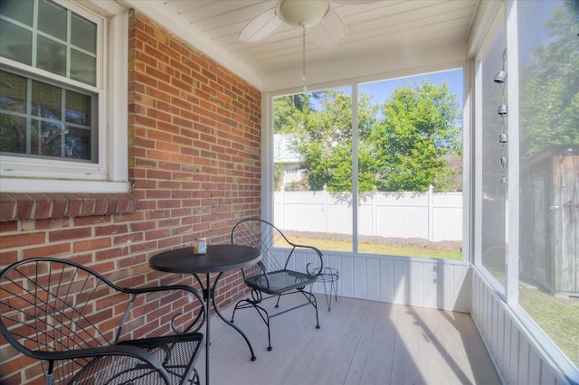 sunroom featuring ceiling fan and a wealth of natural light