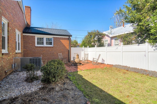 view of yard featuring central AC, a patio area, and a fenced backyard