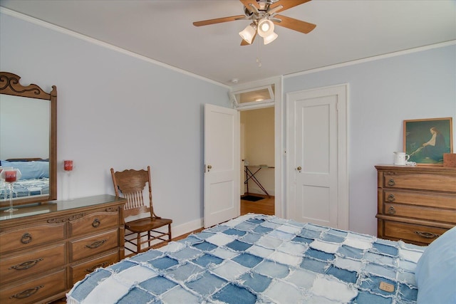 bedroom featuring ceiling fan, ornamental molding, attic access, and baseboards