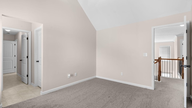 interior space with light carpet and lofted ceiling