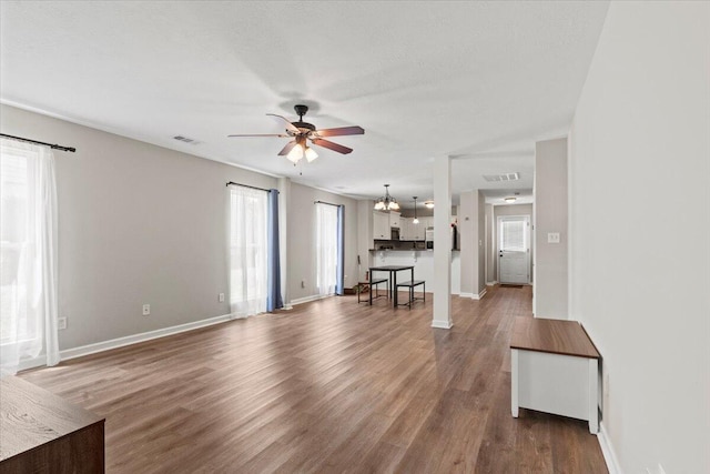 3382 Grove Landing Cir, Grovetown, GA 30813 - unfurnished living room featuring a ceiling fan, wood finished floors, and a chandelier