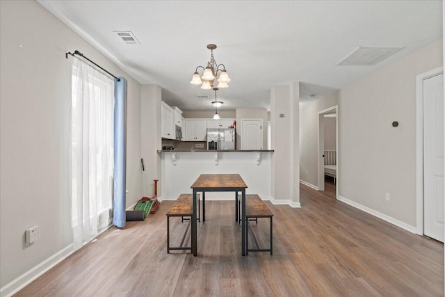 3382 Grove Landing Cir, Grovetown, GA 30813 - dining space with wood finished floors and a chandelier
