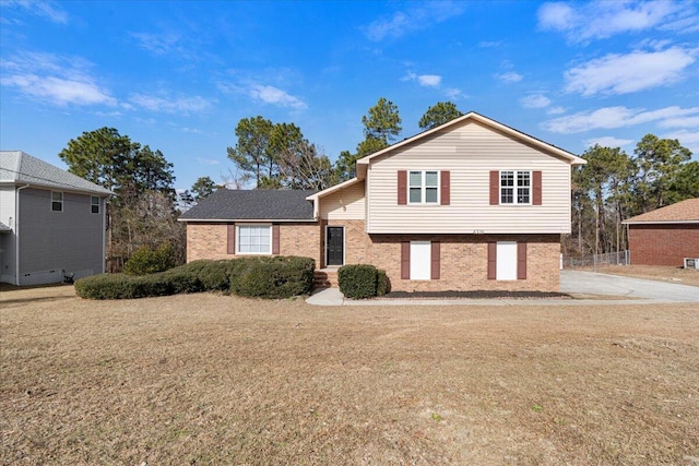 split level home with a front lawn