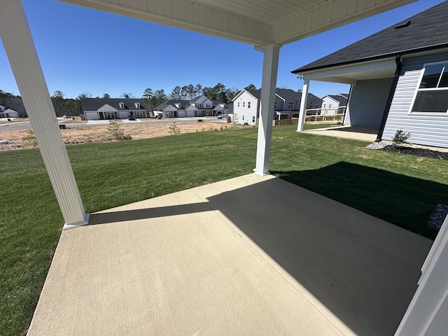 view of yard featuring a patio area and a residential view