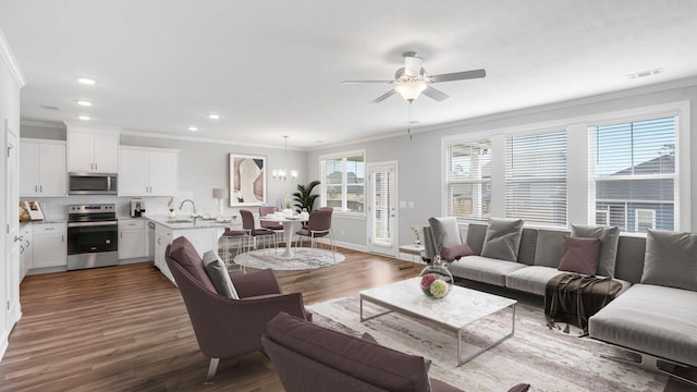 living room featuring hardwood / wood-style floors, ornamental molding, and a wealth of natural light