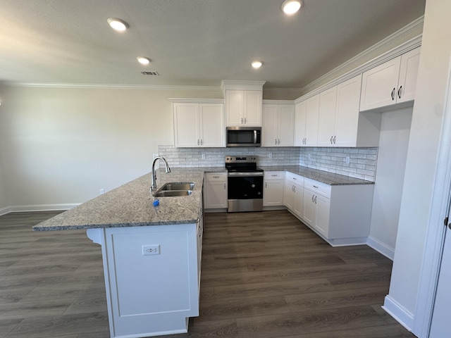 kitchen with visible vents, a sink, light stone counters, appliances with stainless steel finishes, and a peninsula