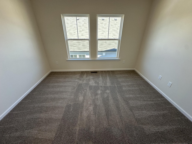 unfurnished room featuring baseboards and carpet floors