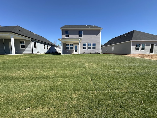 back of house featuring a yard