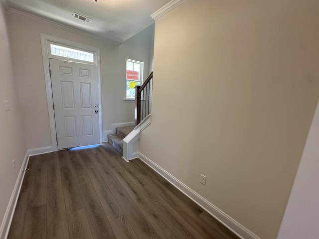 foyer featuring visible vents, baseboards, dark wood finished floors, stairs, and crown molding