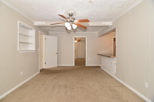 unfurnished room featuring carpet, ornamental molding, and a textured ceiling