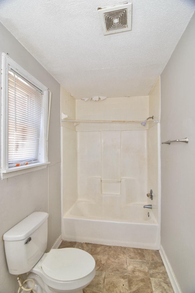 full bathroom with visible vents, a textured ceiling, toilet, and shower / bathtub combination