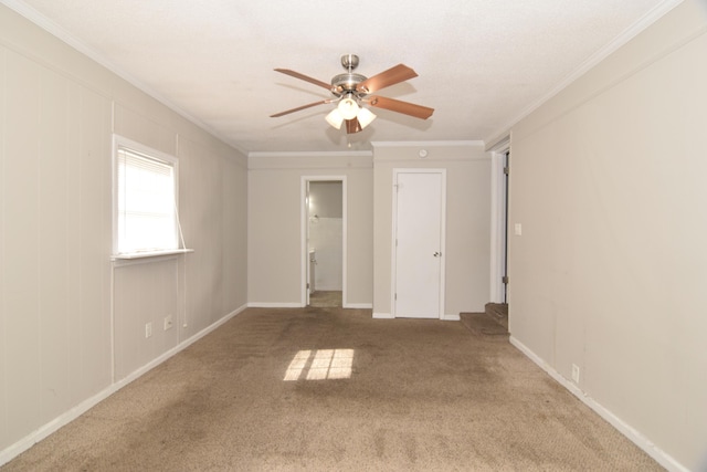 unfurnished bedroom featuring ceiling fan, ornamental molding, carpet, and baseboards