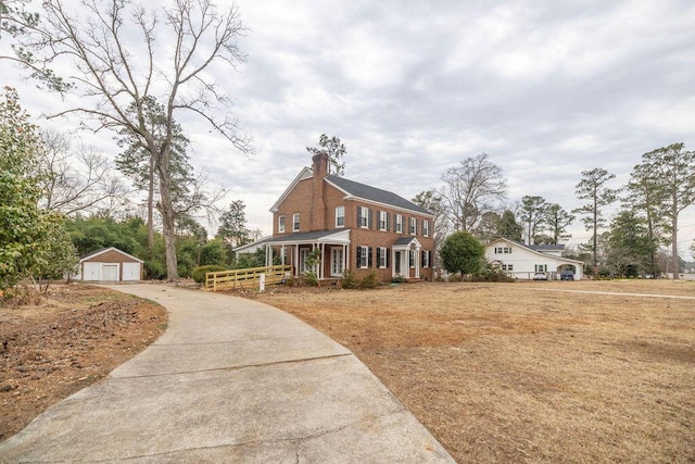 view of front of home with an outbuilding, a porch, and a garage