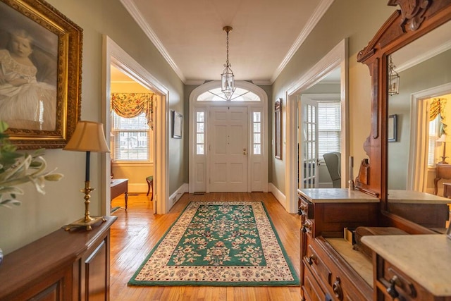 foyer entrance featuring ornamental molding and light hardwood / wood-style floors