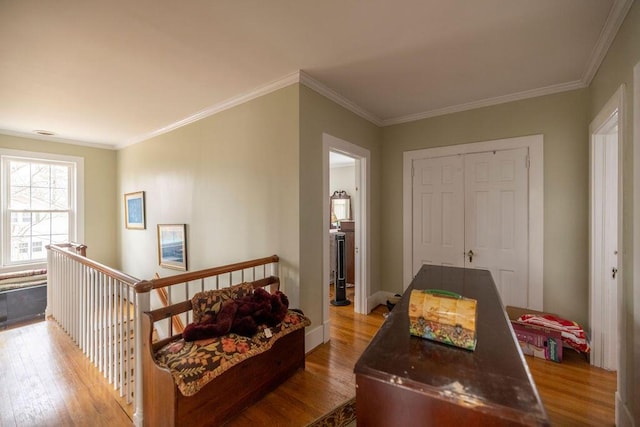 hall with crown molding and light hardwood / wood-style flooring