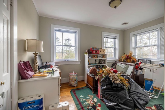playroom with crown molding and light hardwood / wood-style flooring