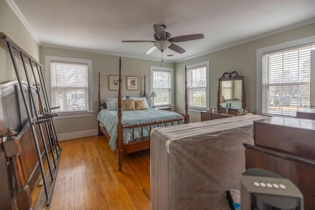 bedroom with ceiling fan, ornamental molding, and light hardwood / wood-style floors