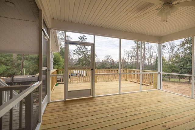 unfurnished sunroom with wood ceiling and ceiling fan